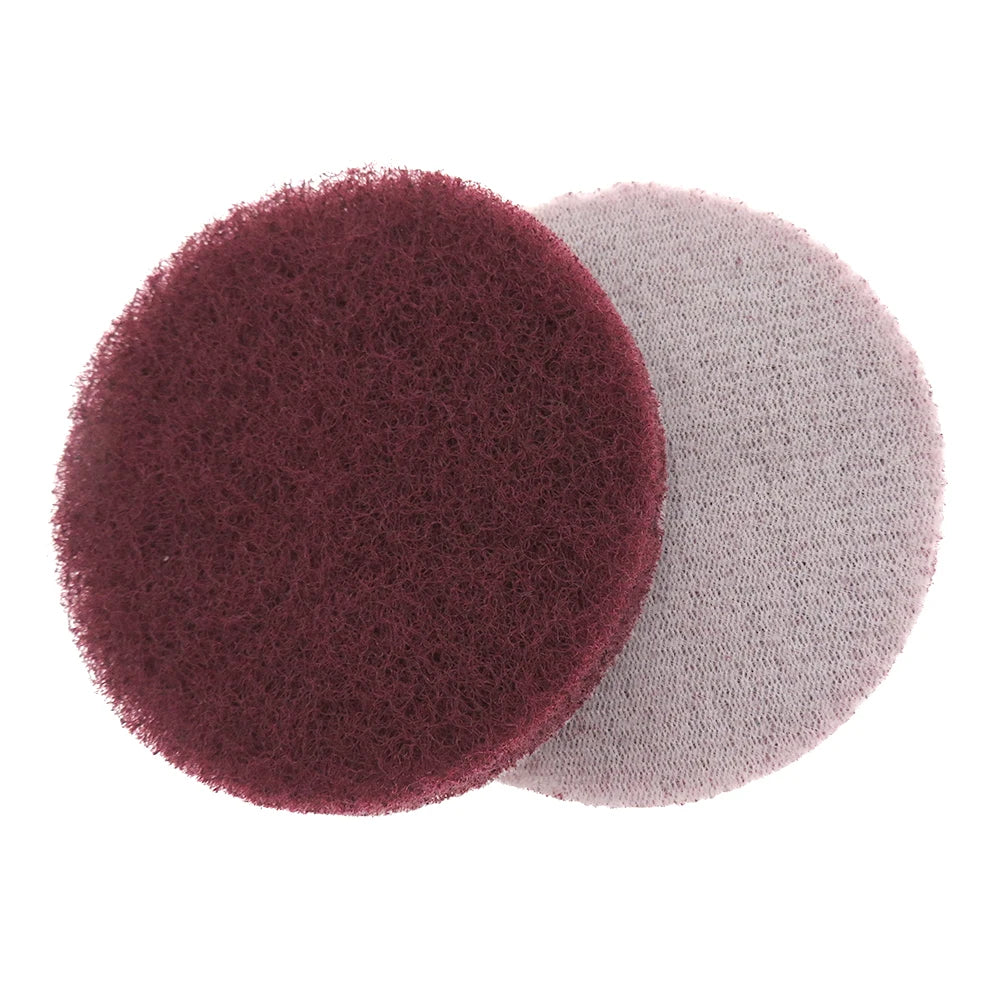 Two circular scouring pads, one dark reddish-brown and one light gray, are shown side by side.