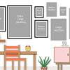 A display of various sized framed art prints and canvases on a wall, next to a wooden desk and chair.