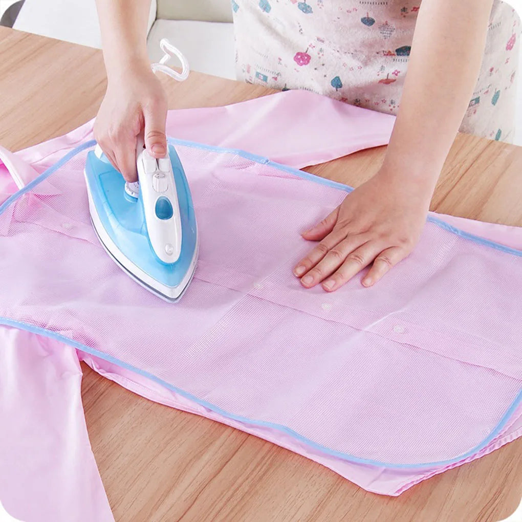 A person is ironing a pink fabric using a handheld blue and white high-temperature protection iron.