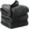 A stack of dark gray microfiber car cleaning and drying towels.