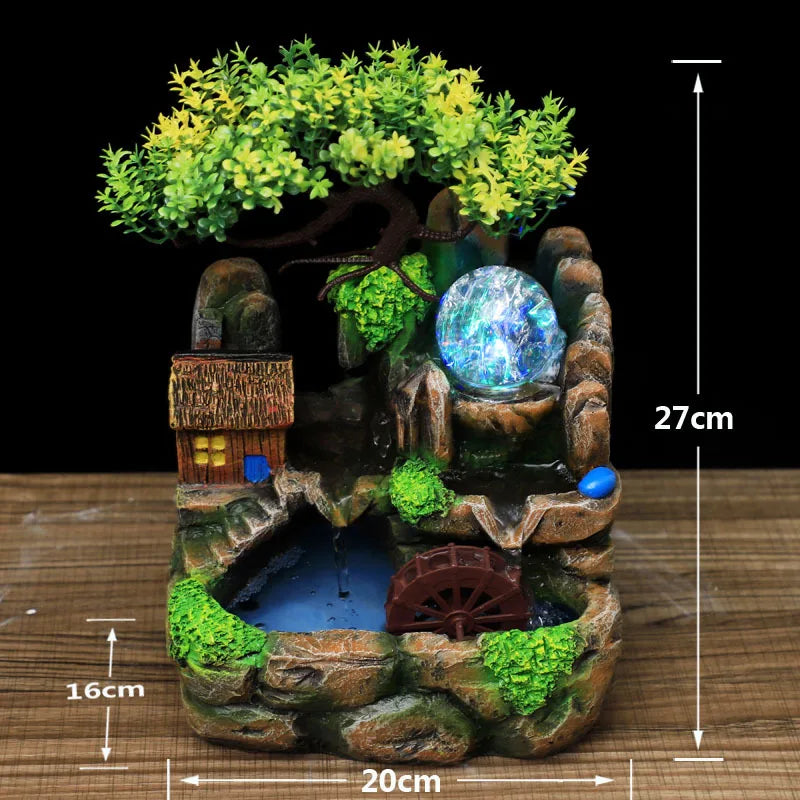 A resin water fountain featuring a mossy landscape, small trees, and a glowing blue orb.