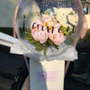 A clear latex balloon is filled with pink flowers and the text Happy 40th Birthday Lauren