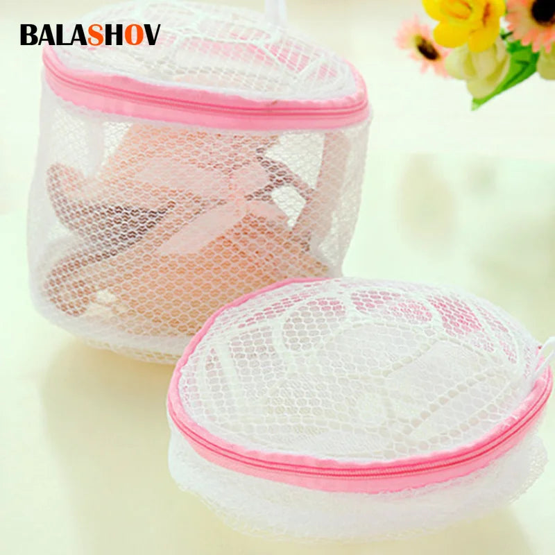 A pink reusable mesh bag for washing lingerie or delicate items.