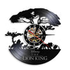 A black vinyl record wall clock featuring a silhouette of a lion and jungle foliage.