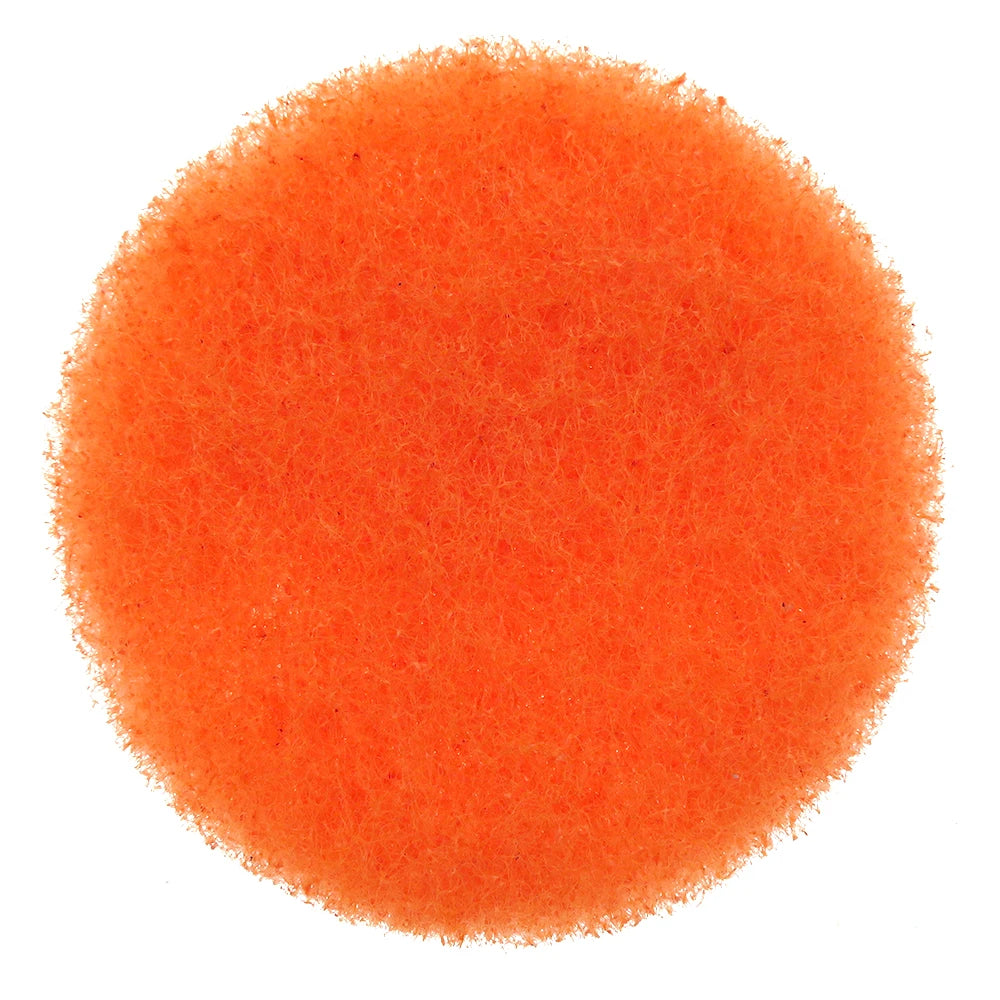 A circular orange scouring pad with a fuzzy texture.