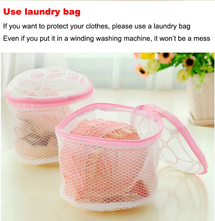 A pink reusable mesh laundry bag filled with clothing, shown on a white surface.