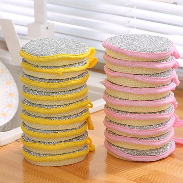 A stack of double-sided dishwashing sponges in yellow and pink colors.