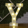 A letter Y made of illuminated LED lights standing on a wooden surface.