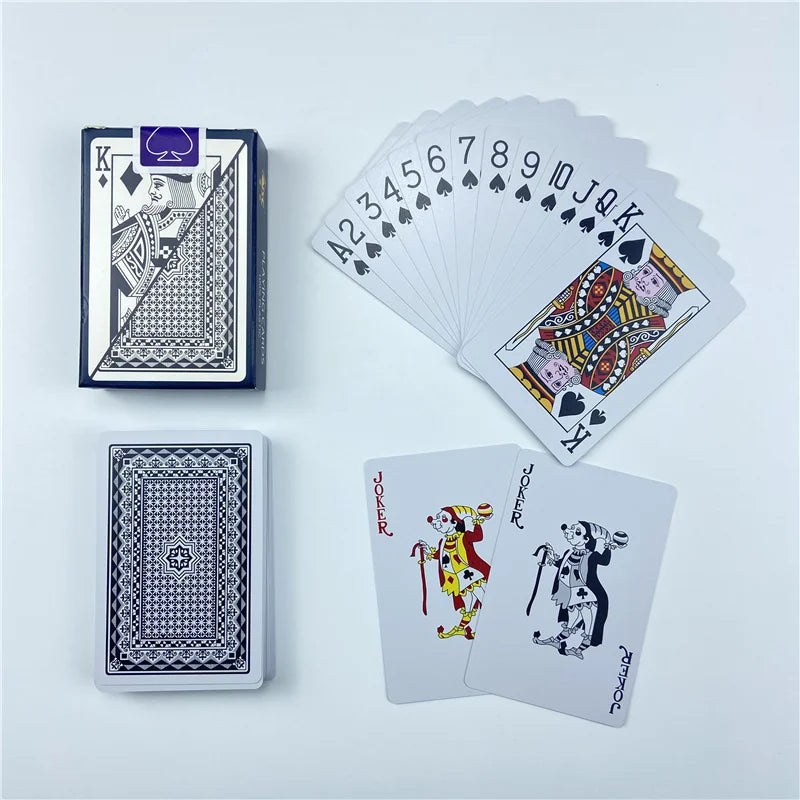 A set of playing cards including a full deck, a stack of cards, and a joker card displayed on a white surface.