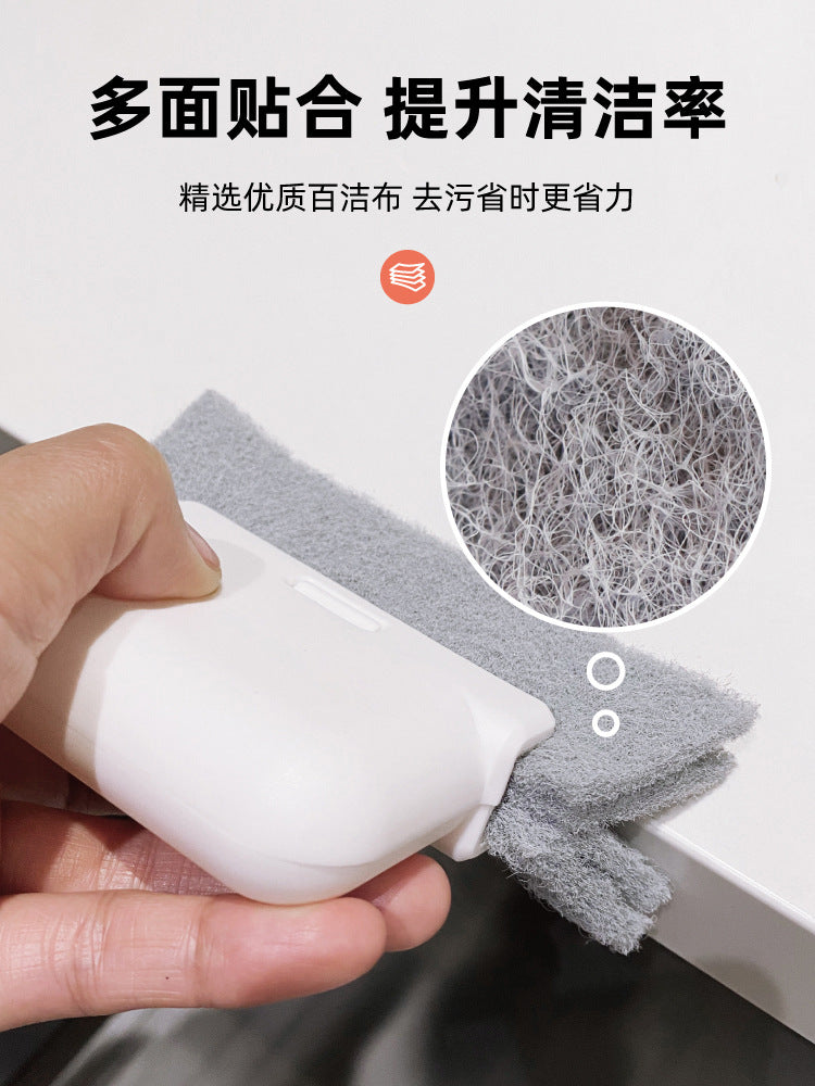 A hand holds a white window cleaning brush with gray cleaning fibers, demonstrating its multi-surface cleaning capability.