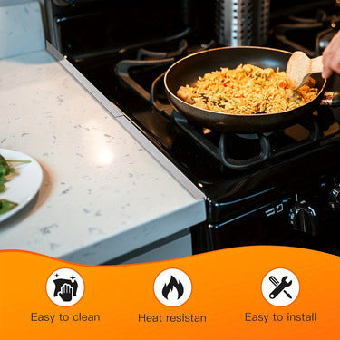 Stainless steel stove gap covers shown on a black stovetop with food cooking in a pan.
