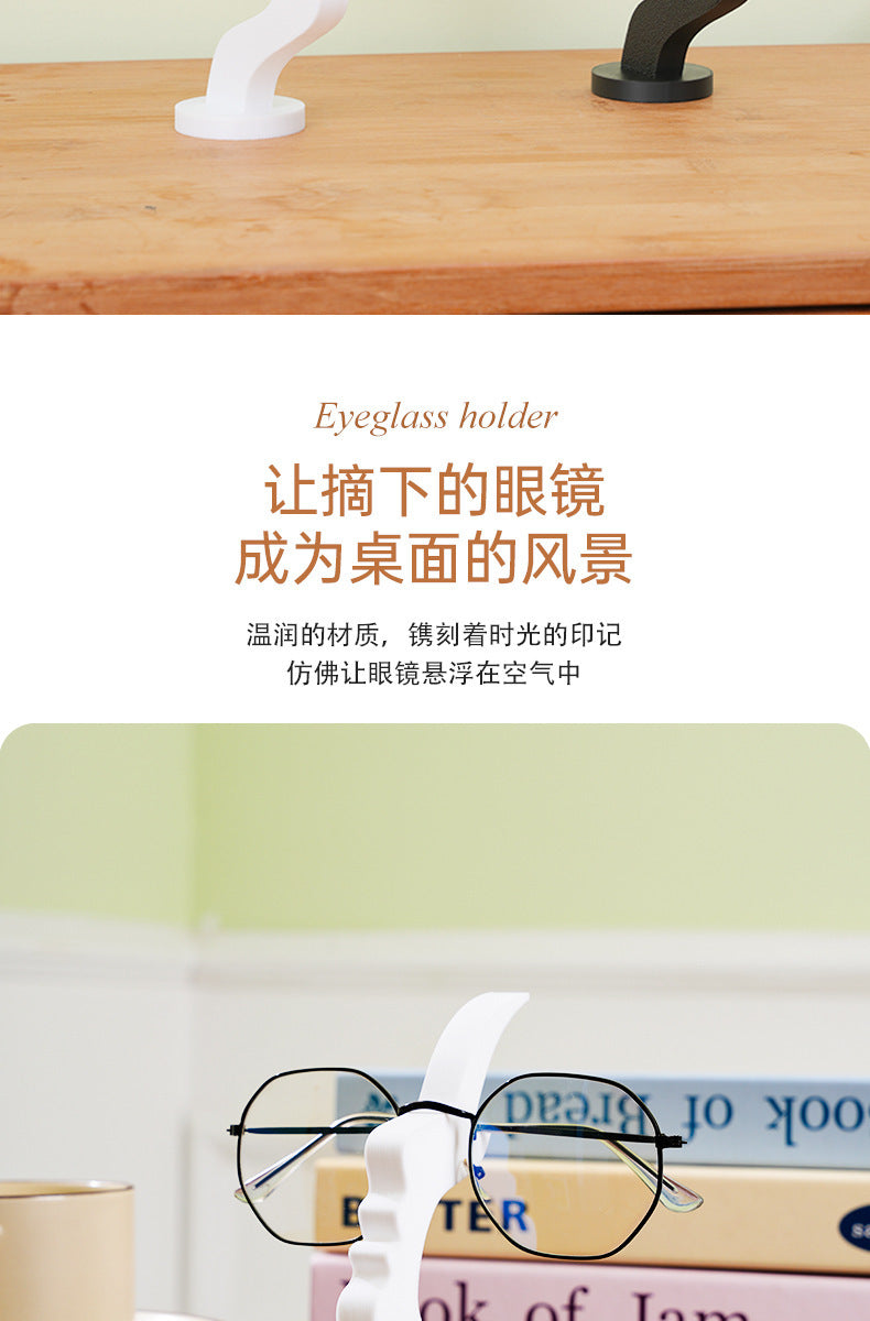A white minimalist 3D printed profile stand for holding eyeglasses.