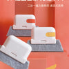 A white window and gap cleaning brush is shown resting on gray foam pads in an orange display setting.