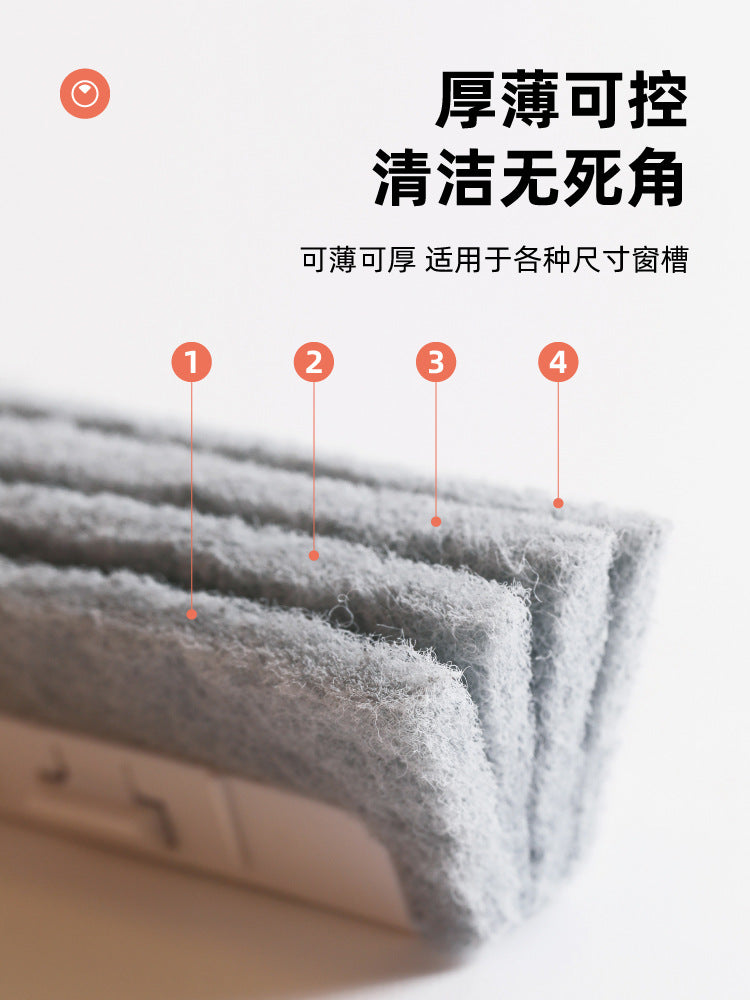 A close-up view of a gray, fibrous cleaning brush being used to clean grooves or gaps.