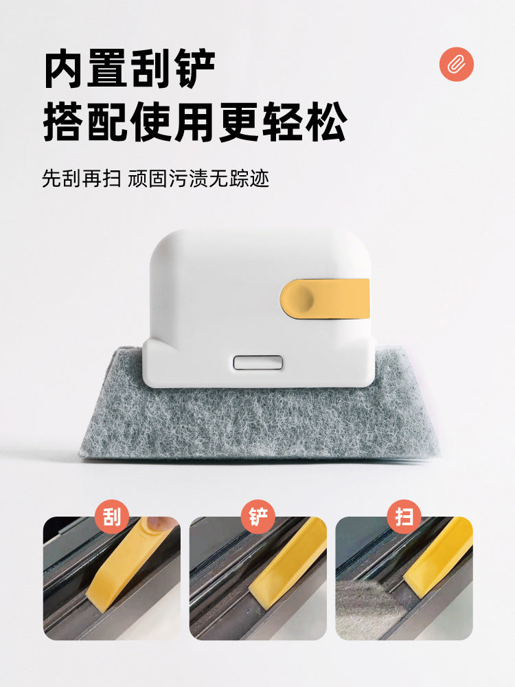 A white multi-purpose groove cleaning brush with a gold accent, shown resting on a gray felt surface.