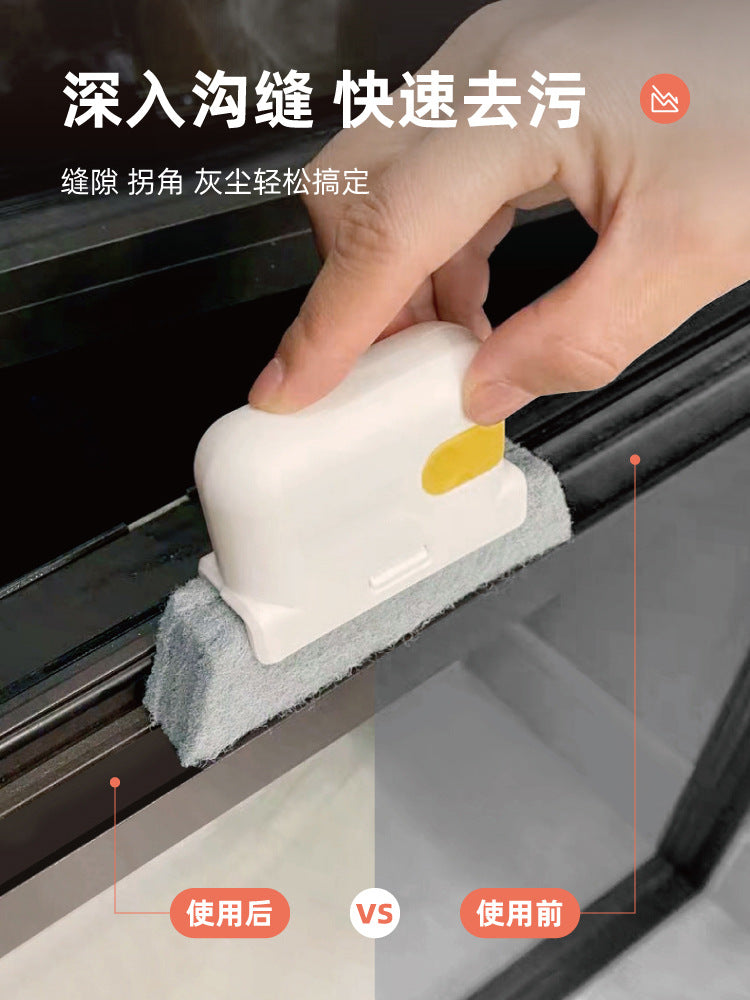 A hand is using a white cleaning brush to quickly remove dirt from a window gap.