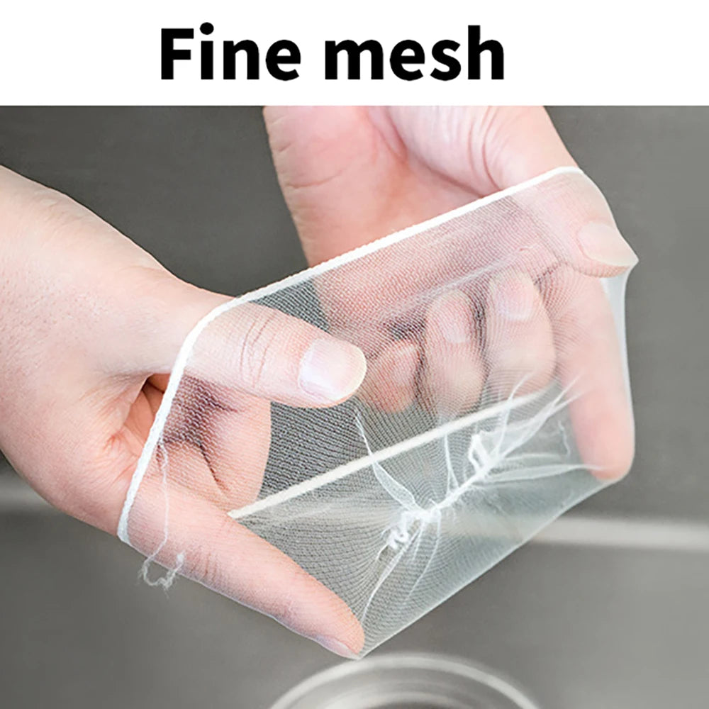 A hand is holding a fine mesh strainer bag, demonstrating its delicate texture and use.