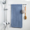A set of self-adhesive curtain rod hooks is displayed on a white tiled wall.