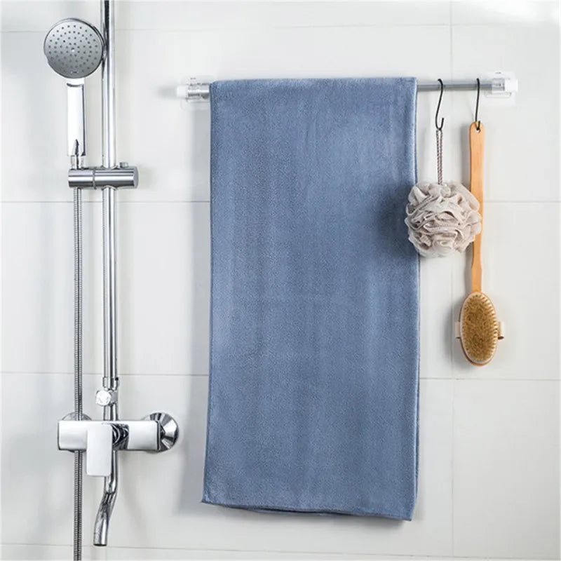 A set of self-adhesive curtain rod hooks is displayed on a white tiled wall.