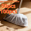 A bundle of 50 or 100 disposable non-woven broom covers being used on a wooden floor.