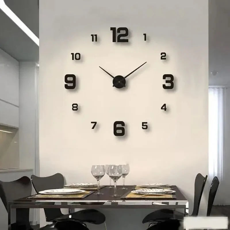 A round black wall clock with Roman numerals is mounted on a white wall above a glass table.