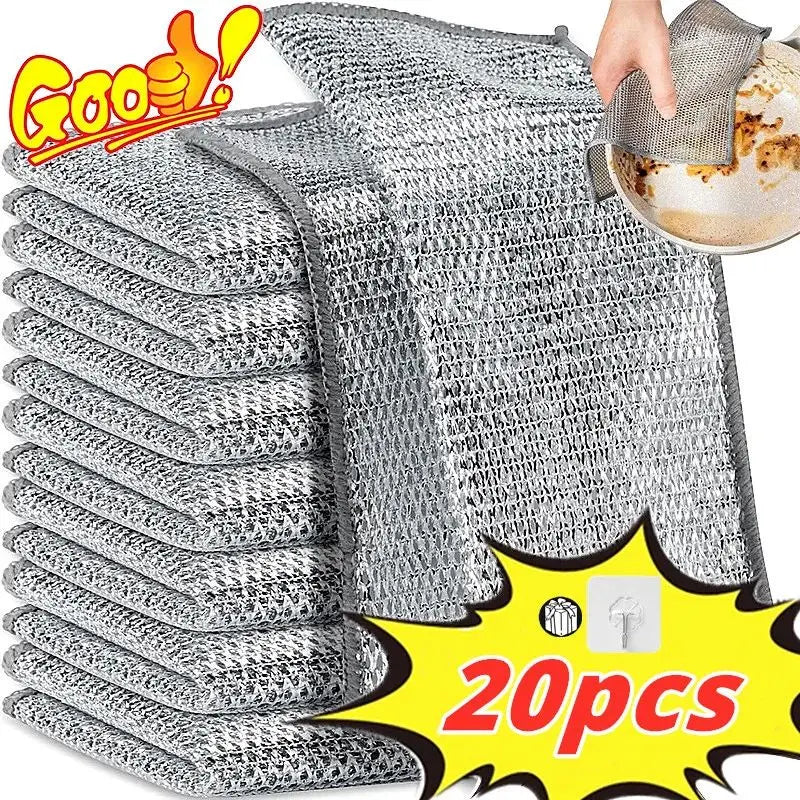 A stack of gray thickened metal wire cleaning cloths with one cloth being held above them.