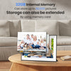 A digital photo frame displaying a family portrait, sitting on a wooden table.
