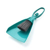 A teal mini broom and dustpan set with a handle and bristles for cleaning desks and keyboards.