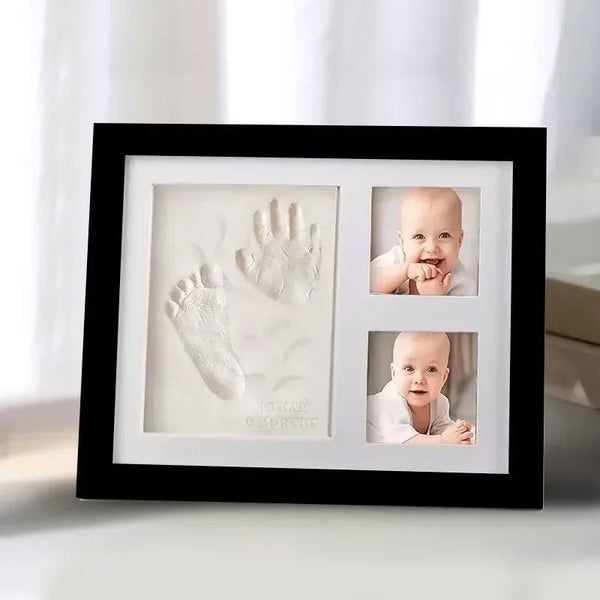 A black framed keepsake featuring a baby's hand and foot print in a clear display box.
