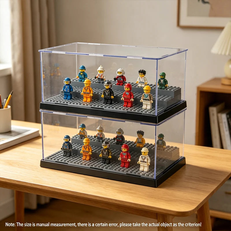 A clear acrylic display case holds various miniature collectible figures in a tiered arrangement on a wooden table.