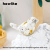 A white crystal bird statue made of natural crystal fragments bonded with resin resting on a white marble surface.