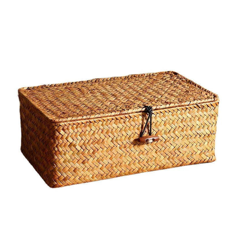 Handwoven rattan storage basket with a lid made of natural woven material.