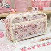 A pink transparent pencil pouch with a floral pattern is displayed on a wooden surface.