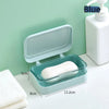 A light blue transparent drainage soap dish with a white bar of soap is shown next to a white dispenser.