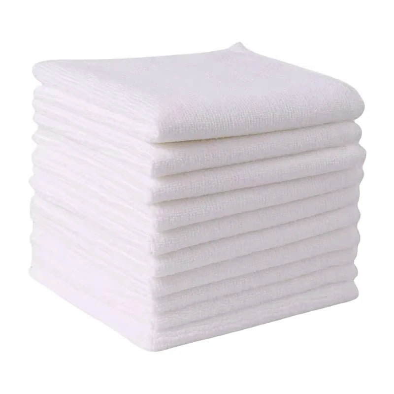 A stack of ten white reusable microfiber cleaning cloths.