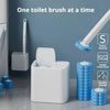 A white toilet brush cleaning kit with a handle and multiple blue sponge brush heads is shown on a gray surface.