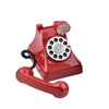 A red retro telephone prop with a circular dial and a sign that reads I miss you.
