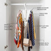A white multi-hook closet organizer hanging in a closet, displaying various scarves, belts, and small bags.
