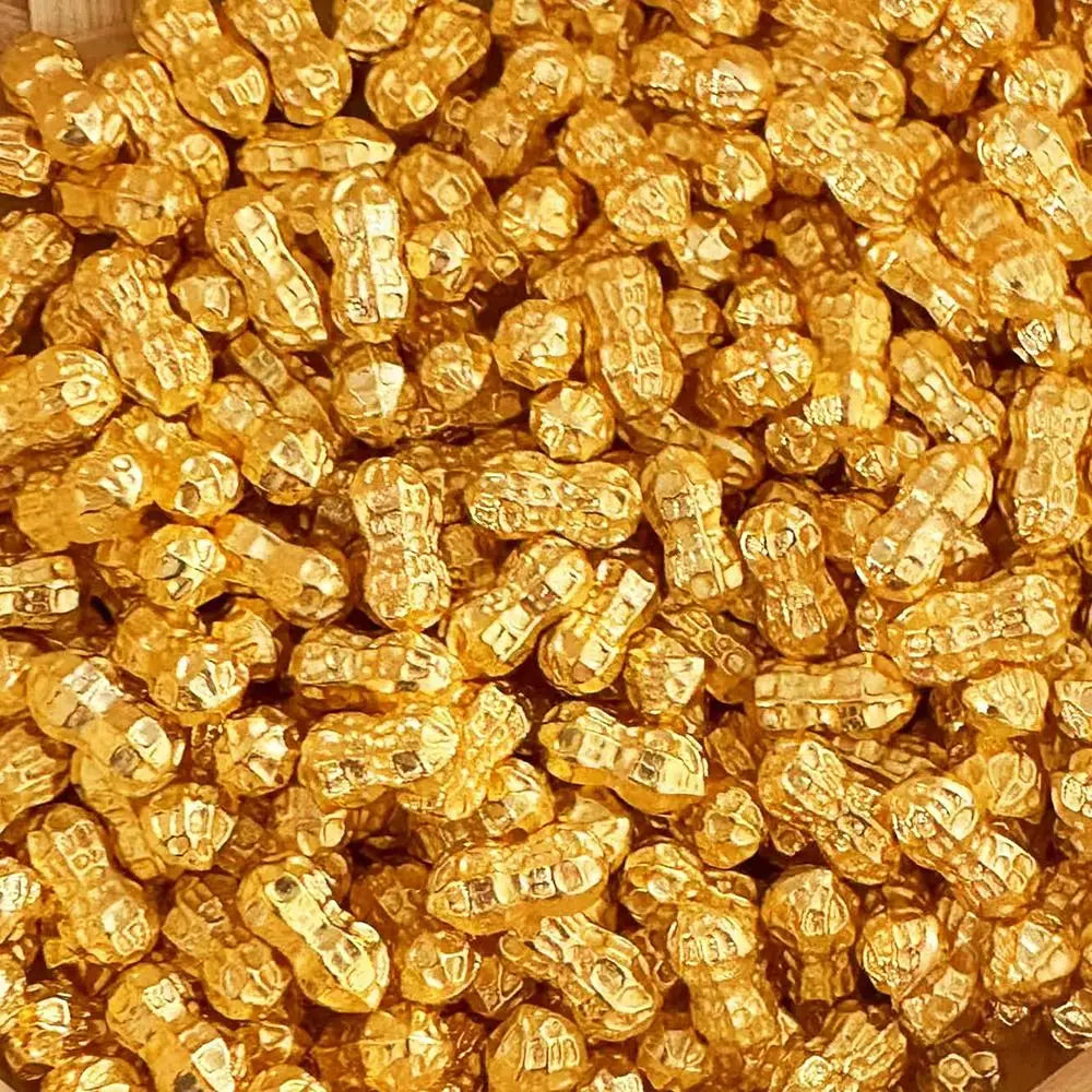 A pile of small, shiny gold bar decorative ornaments.