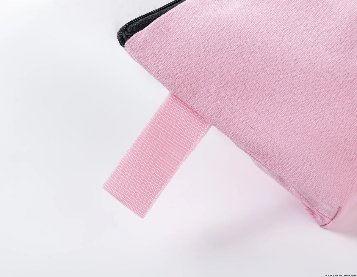 A pink zippered bag with a black trim and a pink strap is shown from the side.