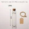 A clear glass bottle with a cork, measuring 22mm in diameter and 80mm in height, shown next to a brown tag.