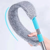 A hand holds an extendable telescopic mop with a gray, fuzzy head and a blue handle.