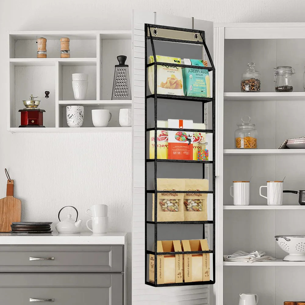 A black over-the-door fabric storage organizer with multiple pockets mounted on a white cabinet.