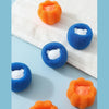 A collection of orange and blue cleaning balls used for washing machine cleaning.