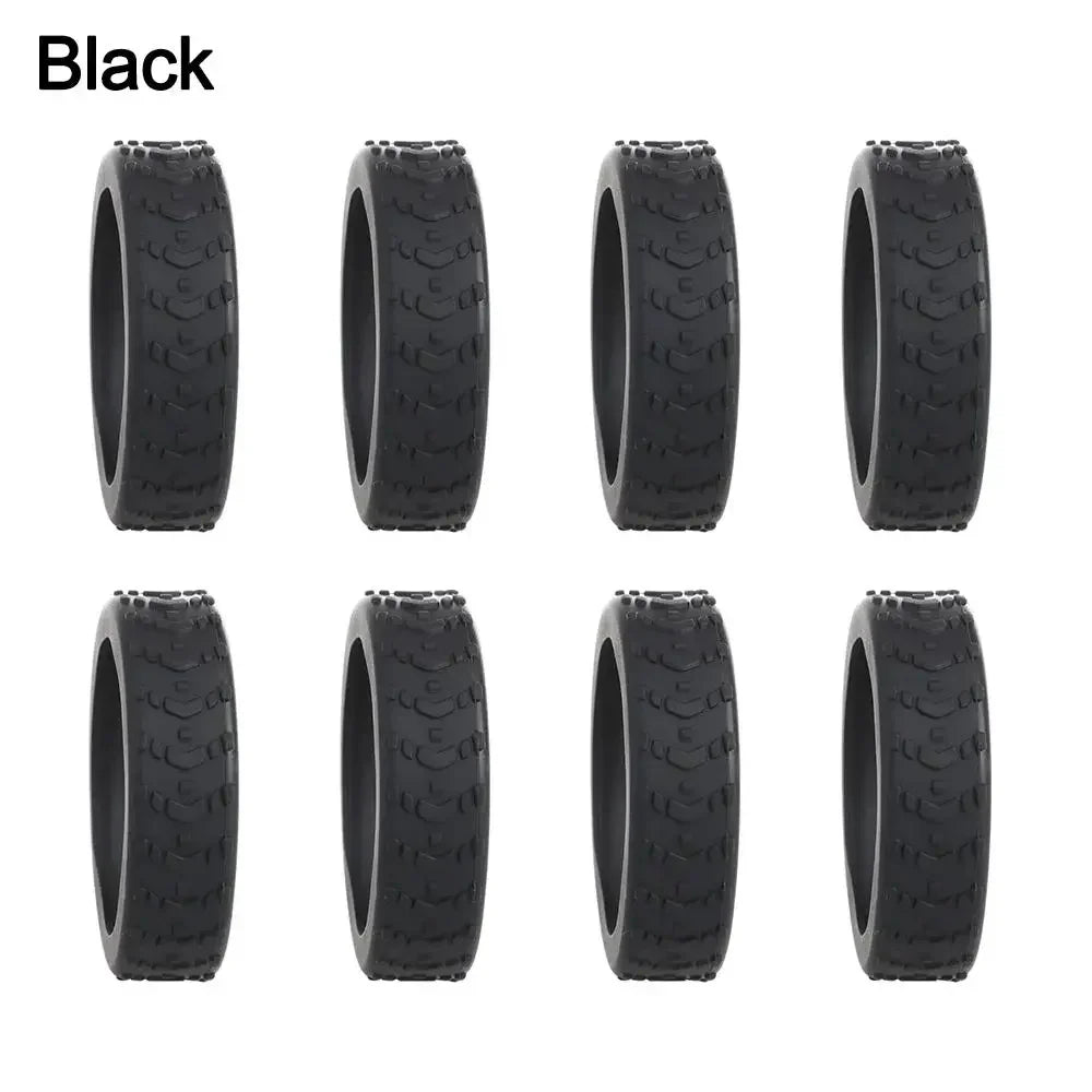 A set of black silicone luggage wheel protectors.