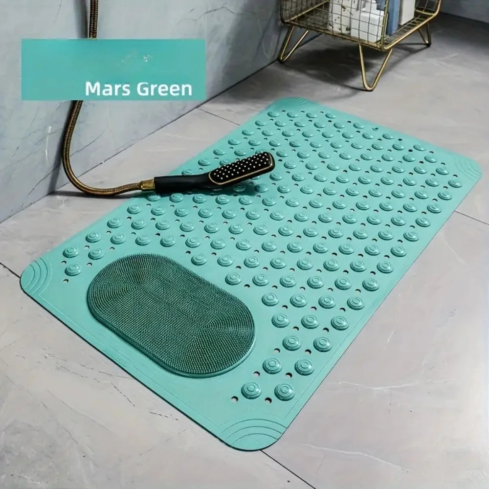 Alfombrilla de masaje anti-resbalar color verde azulado con relieve y una herramienta de masaje verde, sobre un suelo gris cl