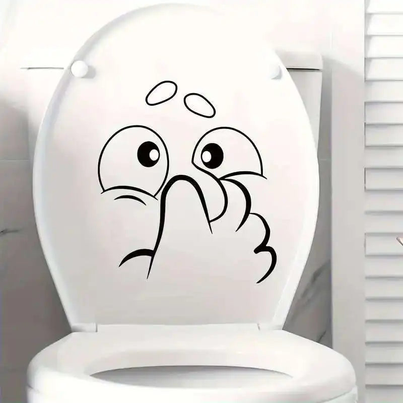 White toilet lid with a funny cartoon face decal showing distress.