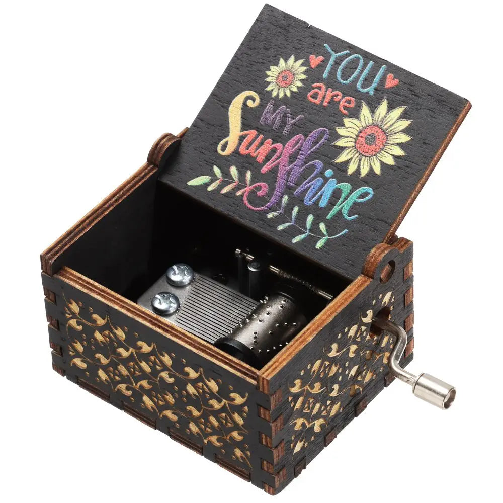 Caja de música de madera manual con tapa abierta que dice "Eres mi sol".