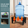 A clear plastic water bottle is placed on a black stool, demonstrating the durability of a bamboo product.