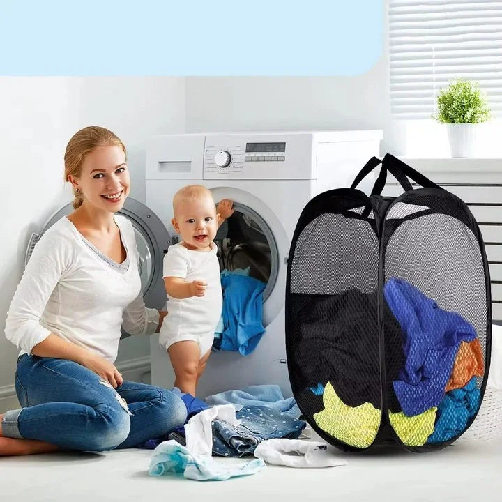 A black foldable mesh laundry basket organizer is shown next to a washing machine.